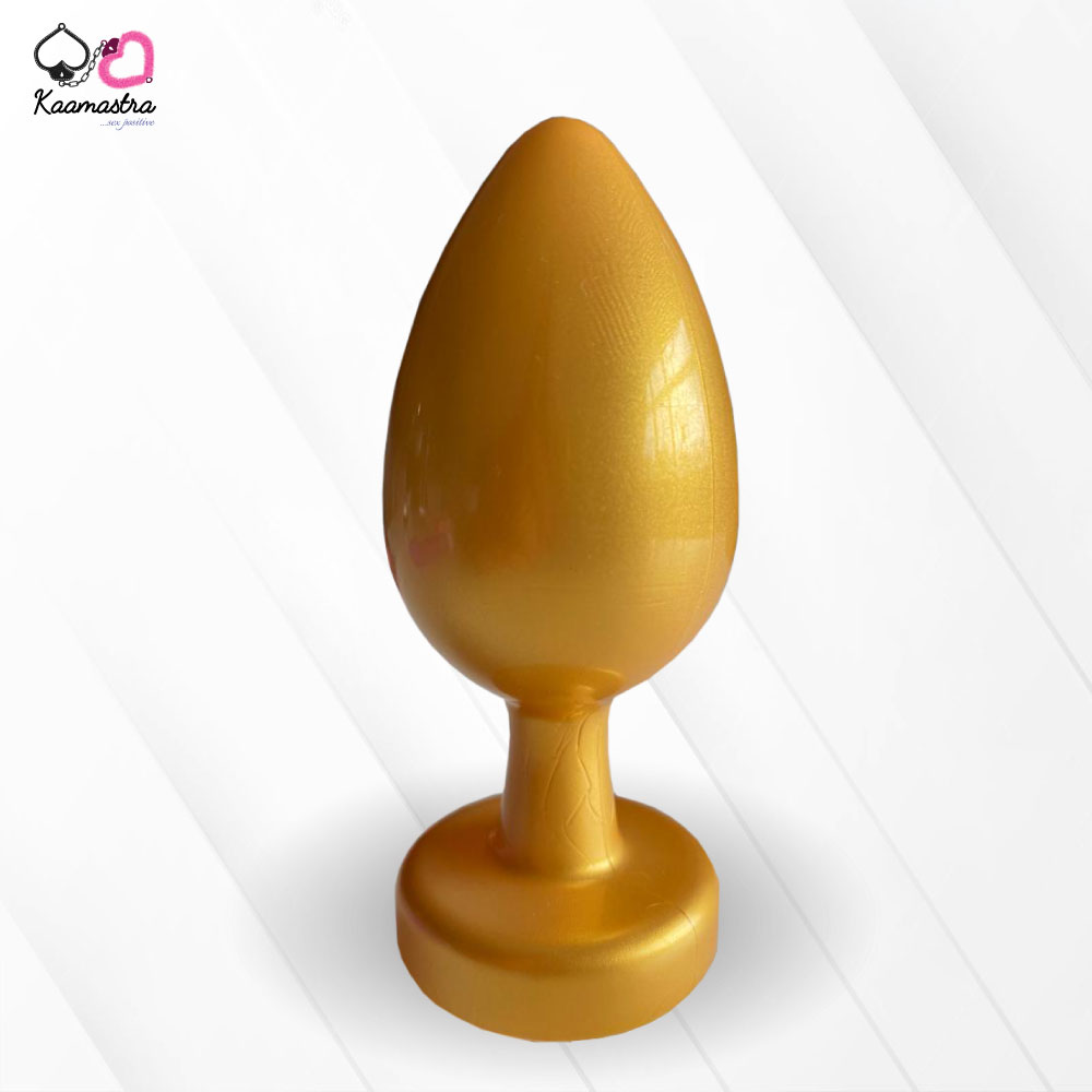 A collection of anal butt plugs in various colors, each featuring a crystal jewel at the base. The plugs are designed in a smooth, egg-shaped form.