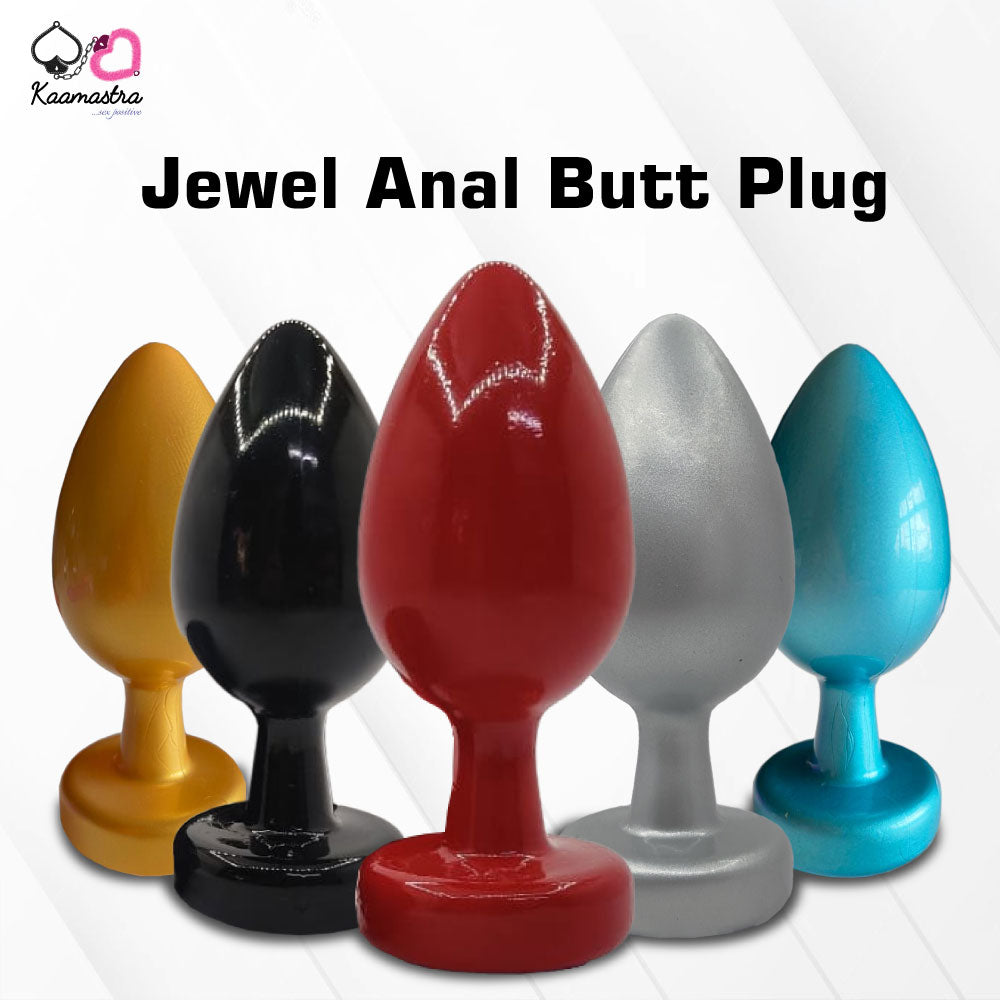 A collection of anal butt plugs in various colors, each featuring a crystal jewel at the base. The plugs are designed in a smooth, egg-shaped form.