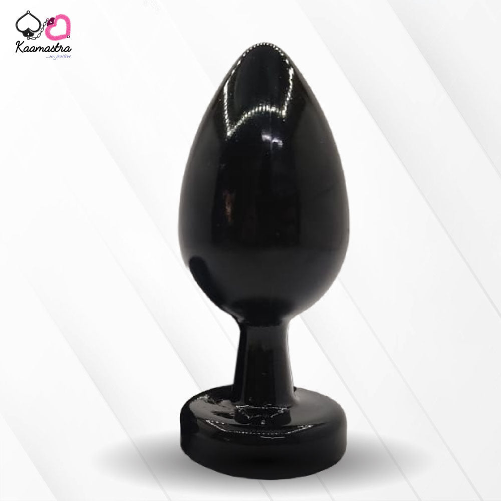 A collection of anal butt plugs in various colors, each featuring a crystal jewel at the base. The plugs are designed in a smooth, egg-shaped form.