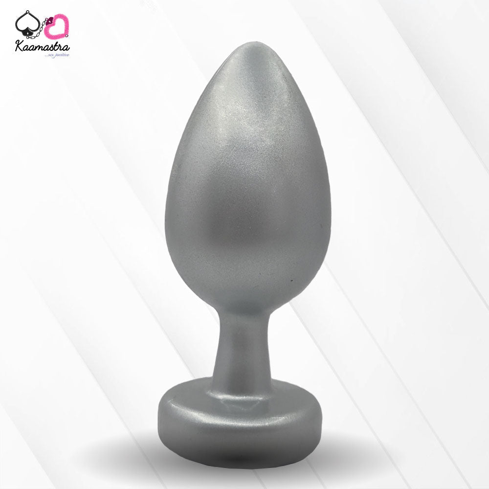 A collection of anal butt plugs in various colors, each featuring a crystal jewel at the base. The plugs are designed in a smooth, egg-shaped form.